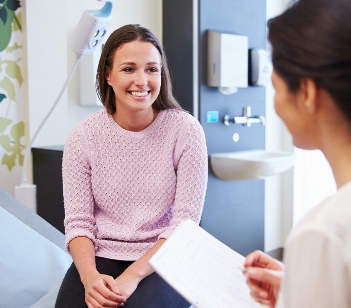 Woman smiling after periodontal treatment under general anesthesia