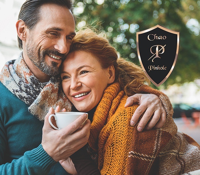 Man and woman with healthy smiles after Chao Pinhole Surgical Technique treatment