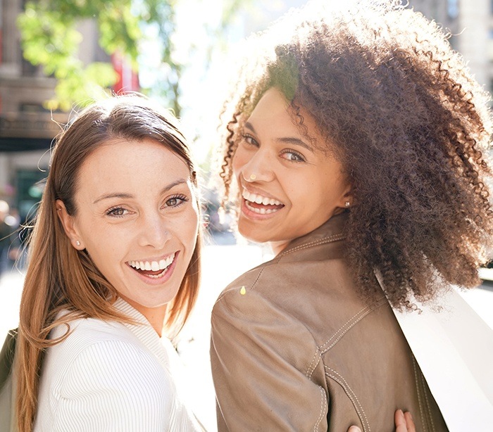 Two women with gorgeous smiles after cosmetic dentistry