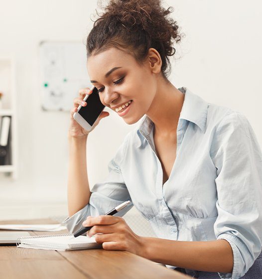 Woman contacting periodontist to learn more about crown lengthening