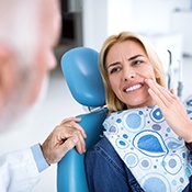 Man in need of emergency dentistry covering his mouth