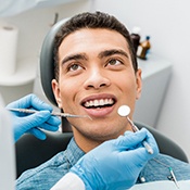 Man with jaw pain holding his mouth