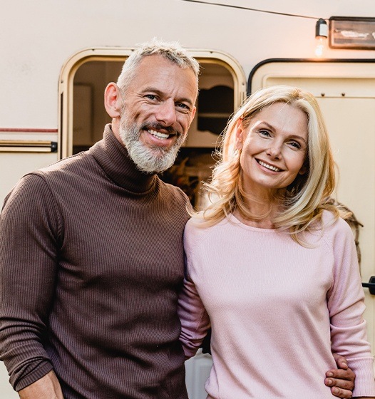 Man and woman smiling after gum surgery consultation