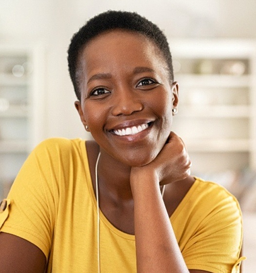 smiling woman showing off her dental implants in Sunnyvale