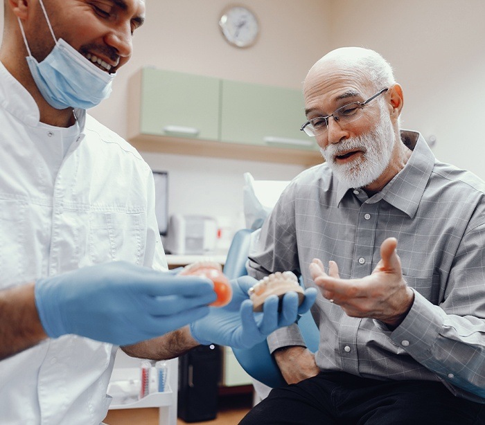 Periodontist and patient discussing dental implant salvage options