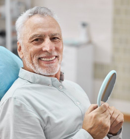 Man with healthy smile after dental implant tooth replacement