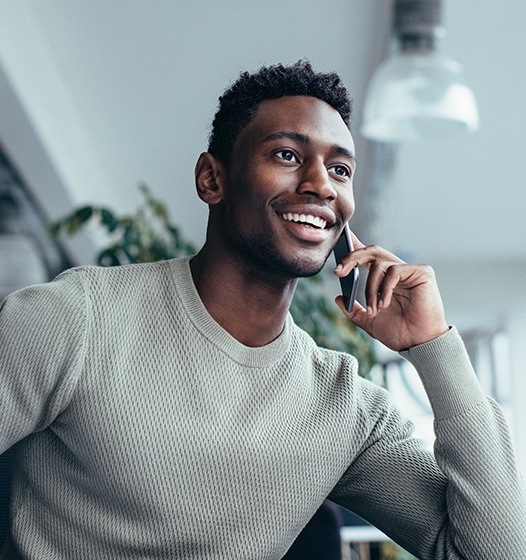 Man contacting periodontist to learn more about gum disease treatment